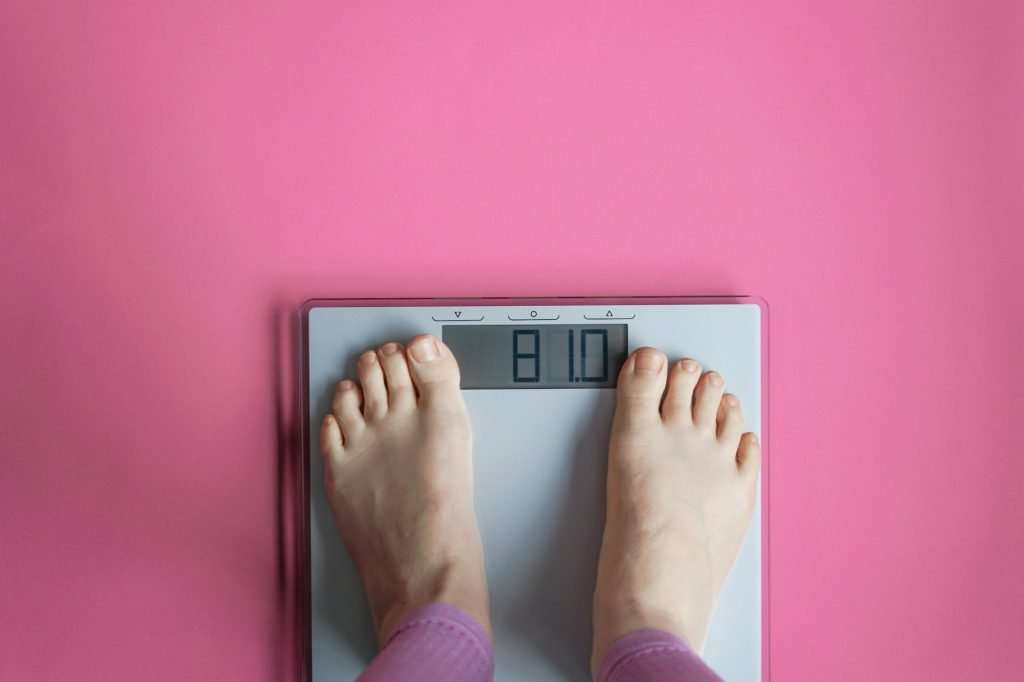 Woman watching her weight . Weight loss. Healthy weight.