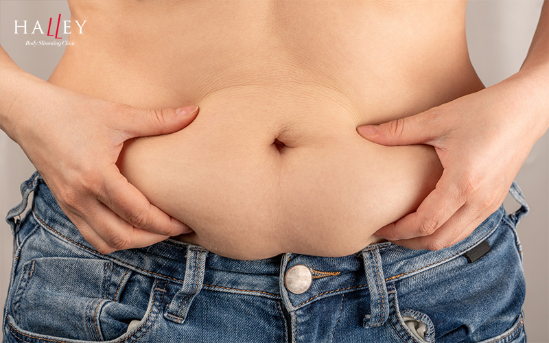Woman with belly fat wearing jeans