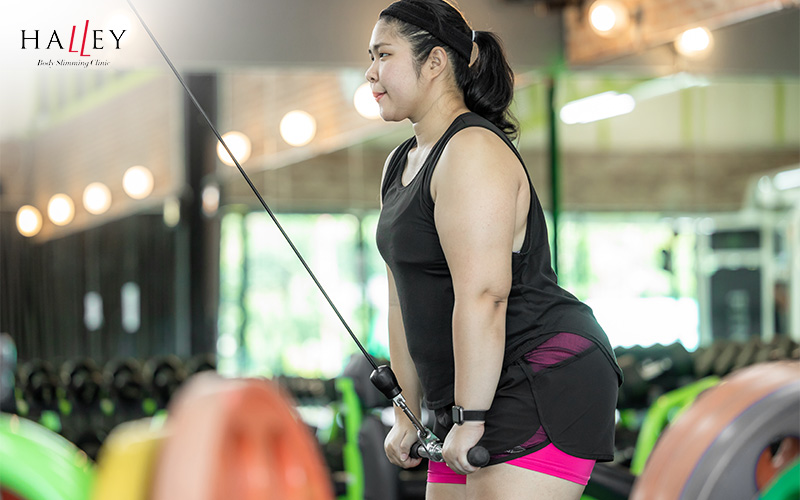 A woman performing a workout to lose fat rolls.