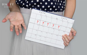 Woman holding calendar with question marks indicating irregular menopause periods