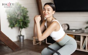 Woman doing squats for glutes muscle toning.